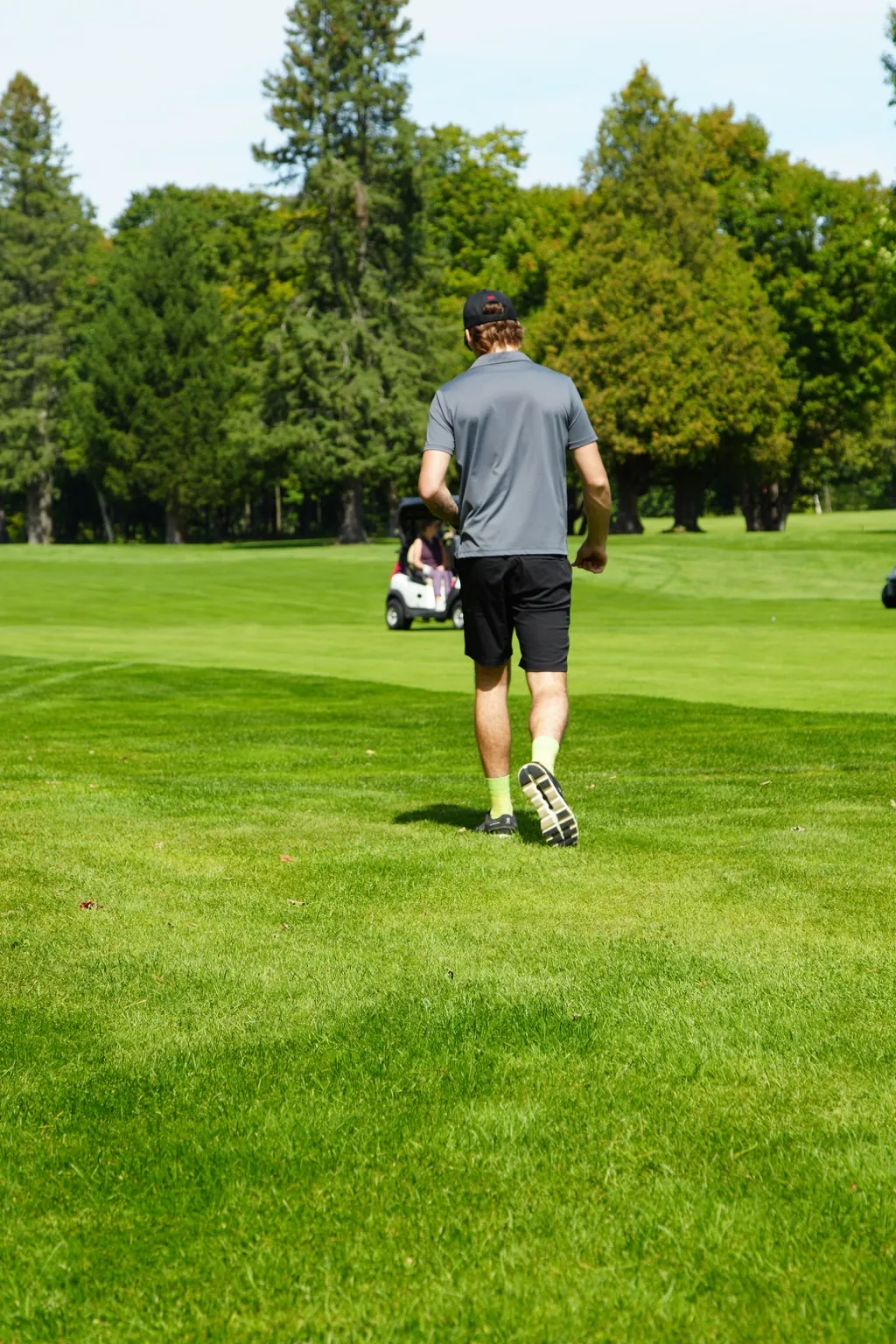 Participant walking on a golf course during a photo production